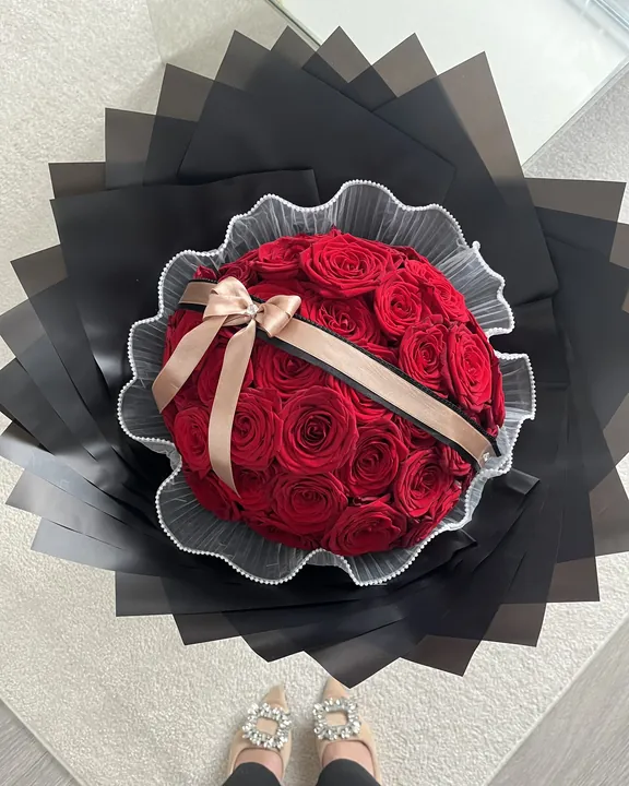 Red rose dome bouquet with a satin bow by Amorella Flower Boutique