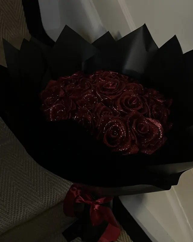 Deep red rose bouquet in black wrap by Amorella Flower Boutique