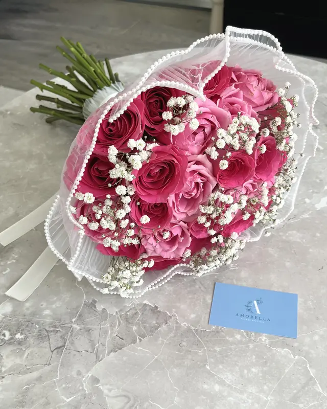 Hot pink rose bouquet with gypsophila and a pearl trim by Amorella Flower Boutique