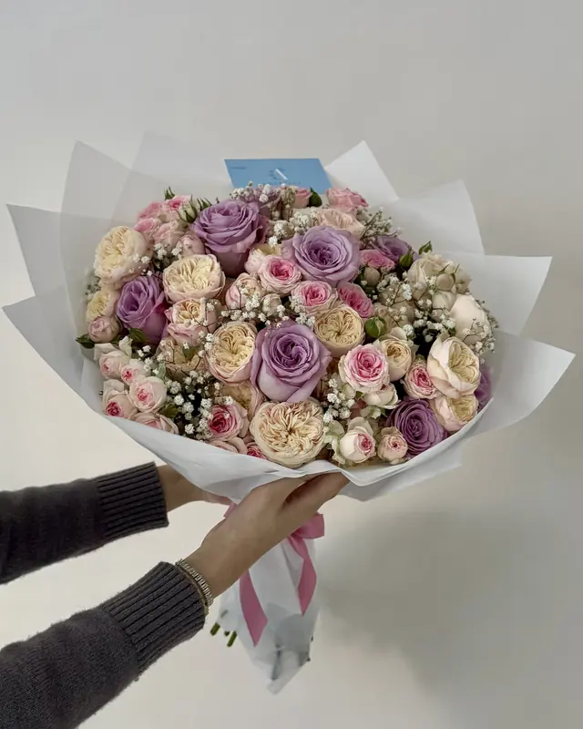 Lilac and peach rose bouquet in white wrap by Amorella Flower Boutique