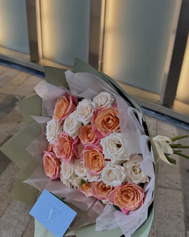 Peach and cream rose bouquet with a gift card by Amorella Flower Boutique