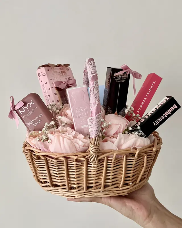 Pink flower gift basket with makeup by Amorella Flower Boutique