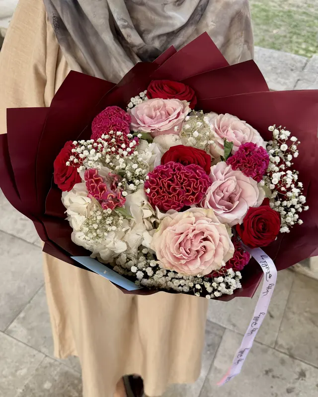 Pink and red rose bouquet in burgundy wrap by Amorella Flower Boutique