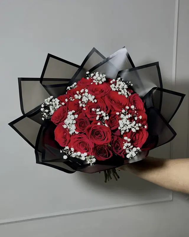Red rose and gypsophila bouquet in black wrap by Amorella Flower Boutique