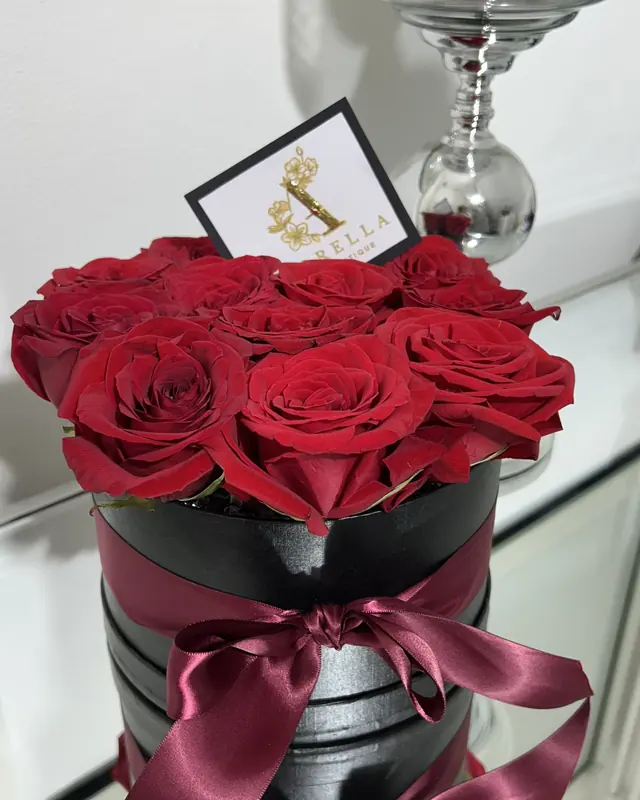 Red rose hatbox with a burgundy ribbon by Amorella Flower Boutique
