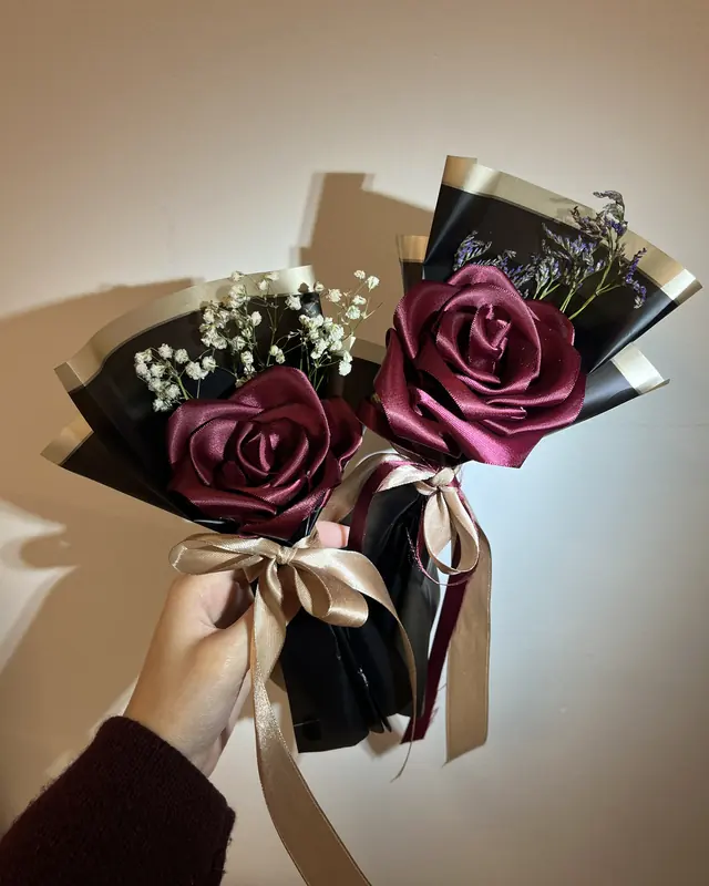 Single ribbon rose bouquets in black wrap by Amorella Flower Boutique