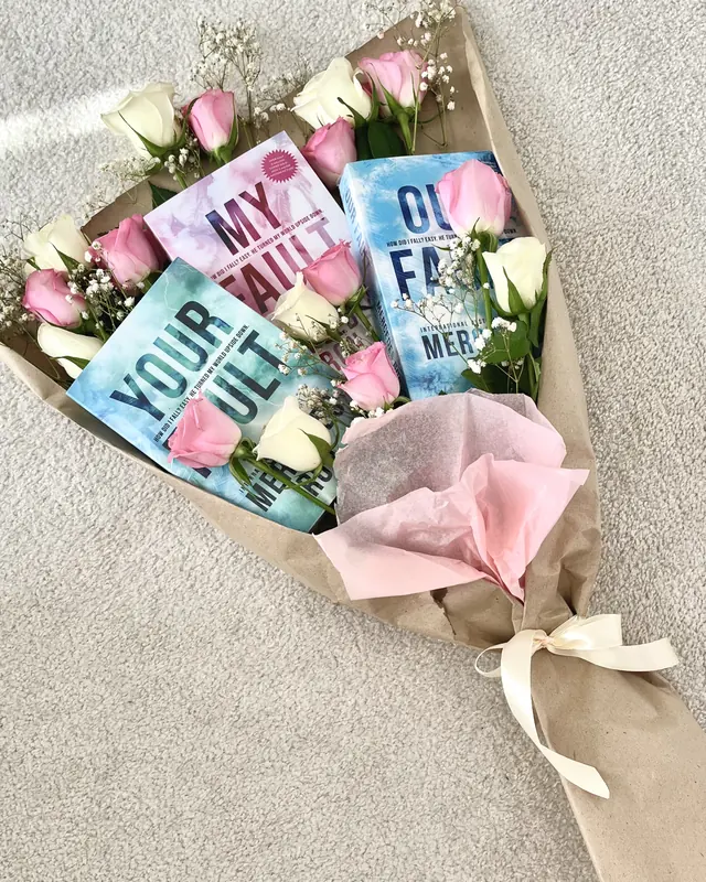 Rose and tulip bouquet with books by Amorella Flower Boutique
